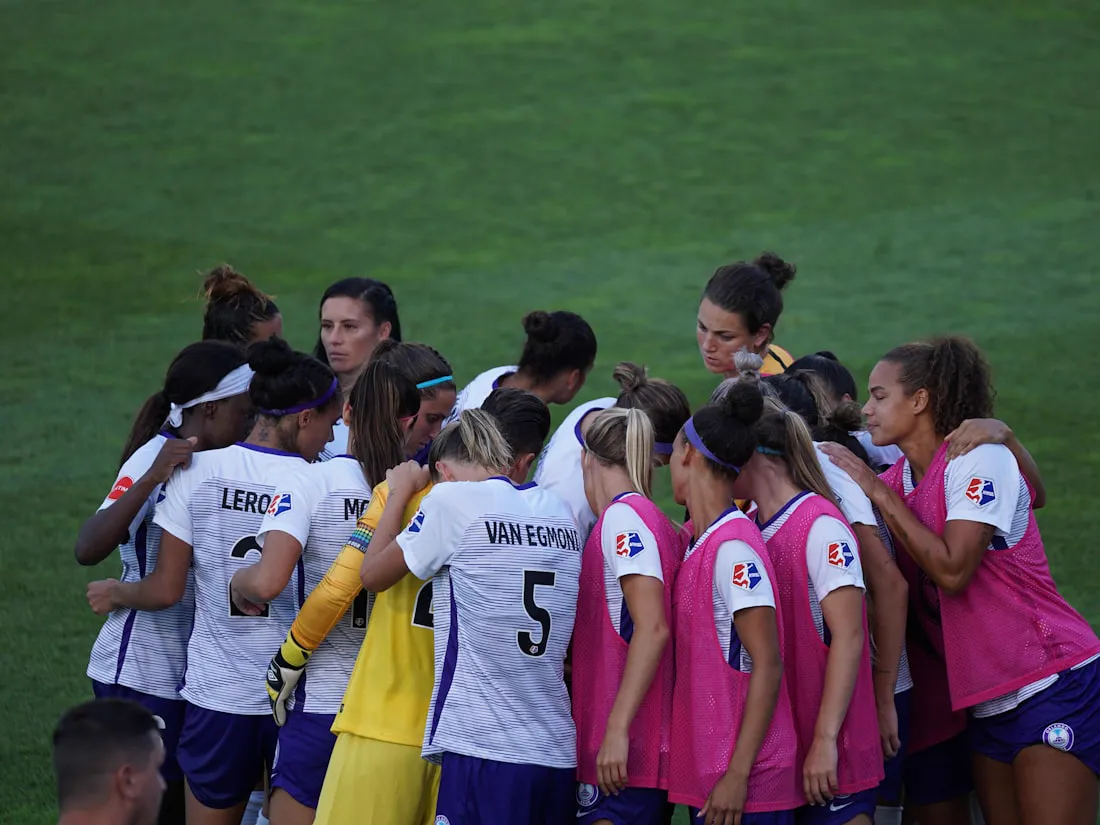 A sports team huddling together
